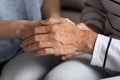 Elderly woman holding hands of young millennial girl demonstrating support Royalty Free Stock Photo