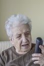 Elderly woman holding a phone Royalty Free Stock Photo