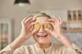 An elderly woman holds bitcoin coins in her hands near her eyes. Seniors retirement happy life concept