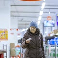 An elderly woman holds a check in her hands