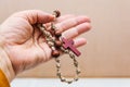 An elderly woman holds the Holy Rosary in her hand. Prayer of the Catholic Church Royalty Free Stock Photo