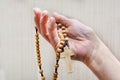 An elderly woman holds the Holy Rosary in her hand. Prayer of the Catholic Church Royalty Free Stock Photo