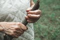 An elderly woman holds a walking stick. Close-up of old  wrinkled and arthritic female fingers Royalty Free Stock Photo