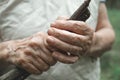 An elderly woman holds a walking stick. Close-up of old, wrinkled and arthritic female fingers Royalty Free Stock Photo