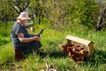 Elderly woman with laptop and chickens in village Royalty Free Stock Photo