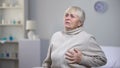 Elderly woman laughing out loud suddenly feeling heart attack, health problems