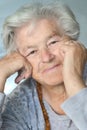 Elderly woman leaning on hands