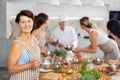 Elderly woman learns to cook at master class