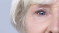 Elderly woman looking into camera, problems with eyes, blurry vision, cataracts