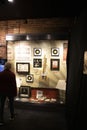 An elderly woman looking at a case filled with memorabilia at the Johnny Cash Museum in Nashville Tennessee