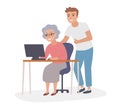 Elderly woman using computer with help of young man