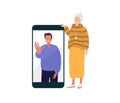 Elderly woman looking at her smartphone and smiling. Young man on screen mobile phone. Elderly mother talks to her adult Royalty Free Stock Photo