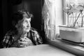 Elderly woman looks wistfully out the window. Royalty Free Stock Photo