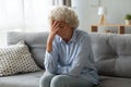 Elderly woman lost in sad thoughts feels miserable and lonely
