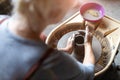 Elderly woman making ceramic work with potter`s wheel Royalty Free Stock Photo