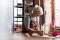 Elderly woman making ceramic work with potter`s wheel Royalty Free Stock Photo