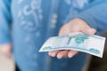 Elderly woman in money in her hands, grandmother holds money