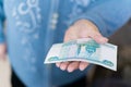 Elderly woman in money in her hands, grandmother holds money