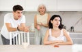 Elderly woman mother and young guy during family quarrel accuse adult daughter Royalty Free Stock Photo