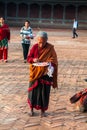 Elderly woman - Newar hurry to make a religious ritual puja