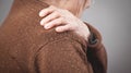 Elderly woman with pain in shoulder Royalty Free Stock Photo