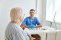 elderly woman patient talking to doctor professional consultant