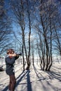 Elderly woman photographs forest