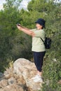 Elderly woman photographs the landscape during a hiking trip Royalty Free Stock Photo