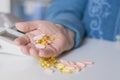 Elderly woman with pills hand, grandmother with medicines