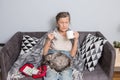 Elderly woman with pills at home. senior woman holding glass of water and pills. Granny holds pills and a cat in her Royalty Free Stock Photo