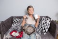 Elderly woman with pills at home. senior woman holding glass of water and pills. Granny holds pills and a cat in her Royalty Free Stock Photo