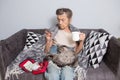 Elderly woman with pills at home. senior woman holding glass of water and pills. Granny holds pills and a cat in her Royalty Free Stock Photo