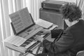 An elderly woman plays the piano in the wedding march in black and white.Editorial use only.Burgas/Bulgaria/04.14.2018/ Royalty Free Stock Photo