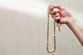 An elderly woman prays the holy rosary. Catholic tradition