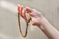 An elderly woman prays the Holy Rosary. Catholic tradition