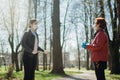 Elderly woman with protective face mask/gloves talking with a friend.Coronavirus COVID-19 disease protection.Conversation from a Royalty Free Stock Photo