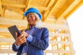 Elderly woman with protective helmet working as an architect doing expertise at construction of ecological renewable low