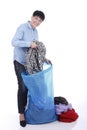 Elderly woman puts used clothes in a big bag