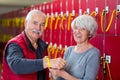 Elderly woman putting locker key on mans wrist Royalty Free Stock Photo