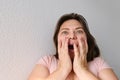 Elderly woman raised her hands in surprise and joy, bright emotions on her face, the concept of a pleasant surprise, a strong Royalty Free Stock Photo