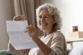 Elderly woman read great news in letter feels happy