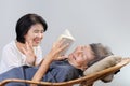 Elderly woman reading fable book with daughter