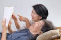 Elderly woman reading fable book with daughter