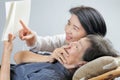 Elderly woman reading fable book with daughter