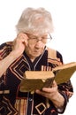 Elderly woman reads the book