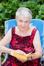 Elderly woman reads a book