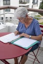 Elderly woman handling administrative documents
