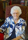 Elderly woman ready to celebrate her 87th birthday with family in her home. Royalty Free Stock Photo