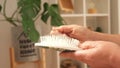 An elderly woman removes long gray hair that has fallen out from comb. Hair care at any age.