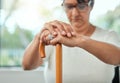 .elderly woman resting her hands on her walking stick while relaxing at home. Royalty Free Stock Photo